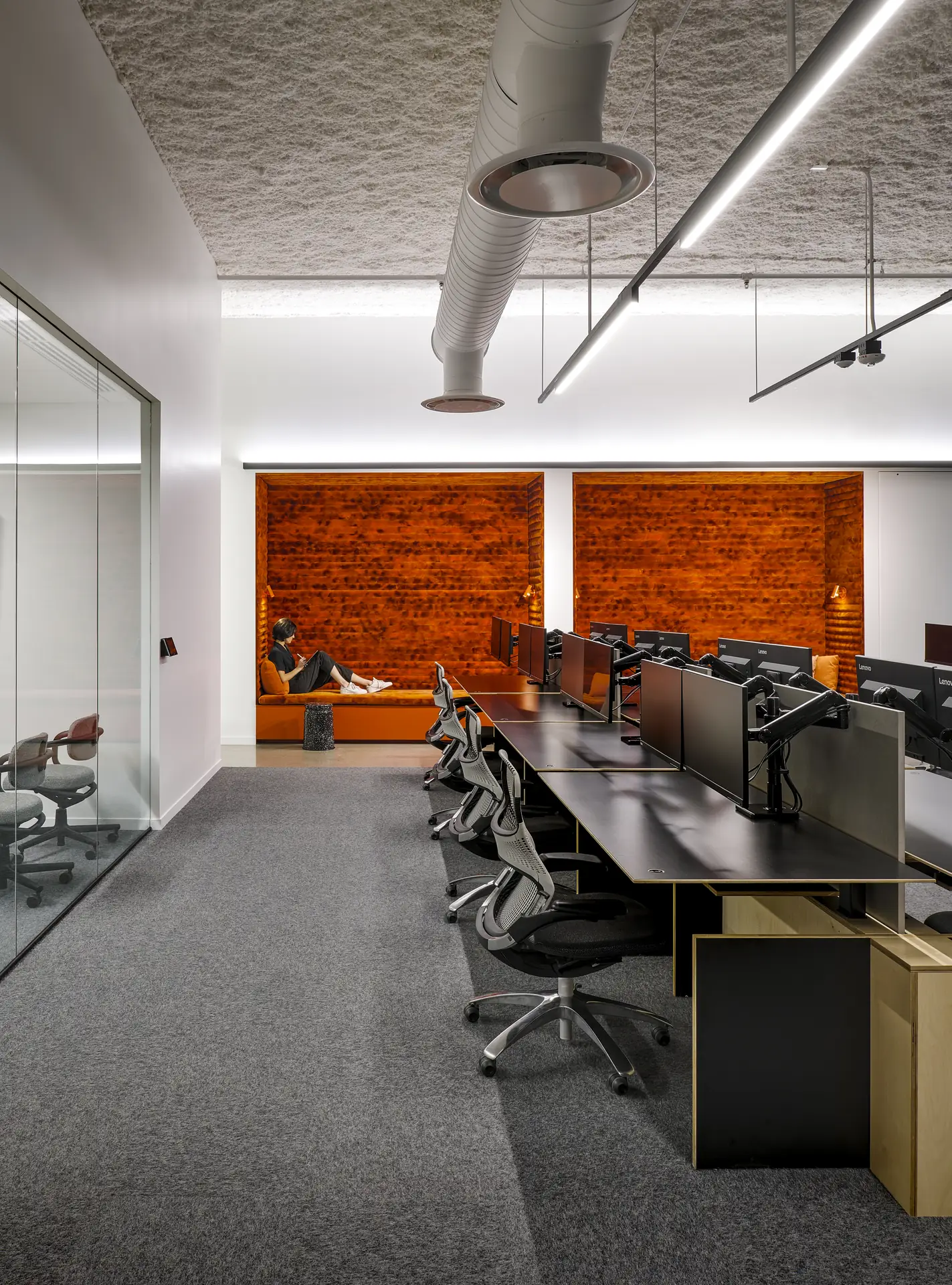 Rows of matching benching workstations across an open-plan office floor